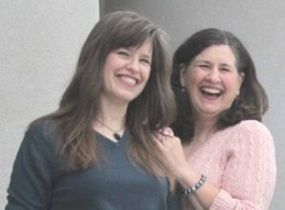 Anna Mumaw and Logan Reed, Founders of Call Me Unstoppable, smiling and standing close together, with Anna wearing a dark top and Logan wearing a light pink sweater.